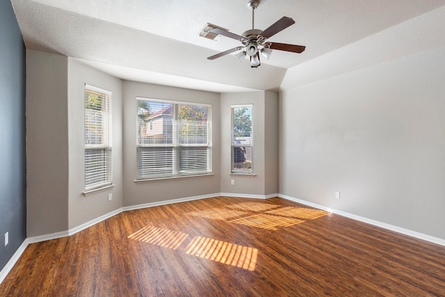 unfurnished room with ceiling fan, a wealth of natural light, lofted ceiling, and wood-type flooring