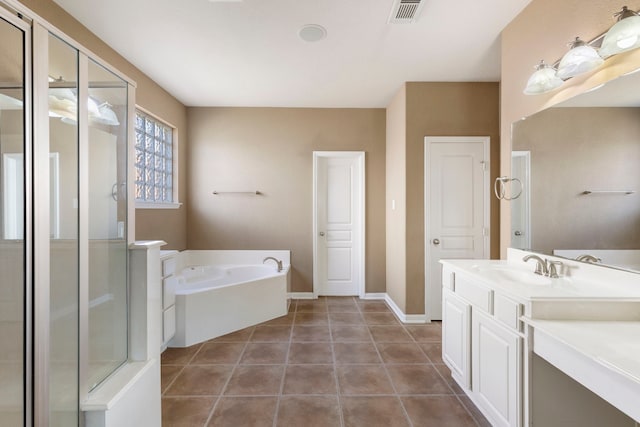 bathroom featuring shower with separate bathtub, vanity, and tile patterned flooring