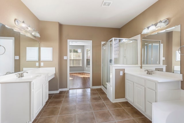 bathroom featuring walk in shower, vanity, and tile patterned floors