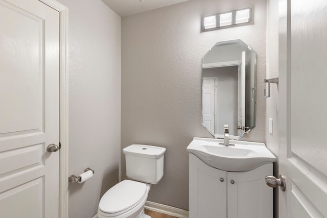 bathroom featuring toilet and vanity