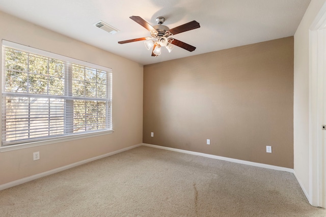 empty room with ceiling fan and carpet floors