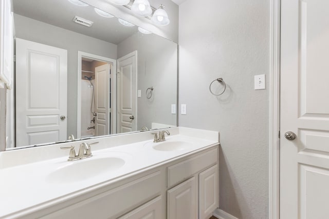 bathroom featuring  shower combination and vanity