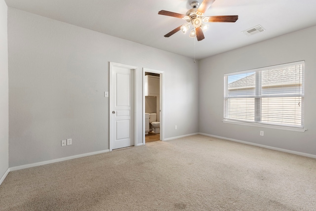 carpeted spare room featuring ceiling fan