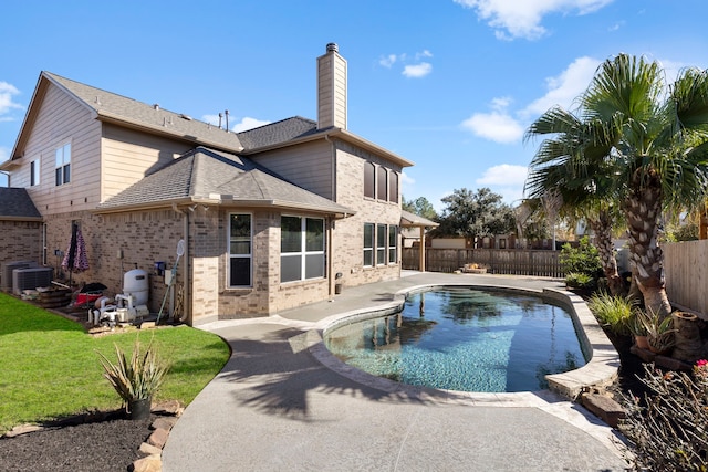 back of house with a fenced in pool, central AC, a yard, and a patio