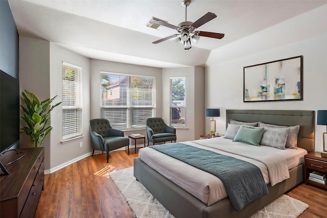 bedroom with ceiling fan, dark hardwood / wood-style flooring, multiple windows, and lofted ceiling