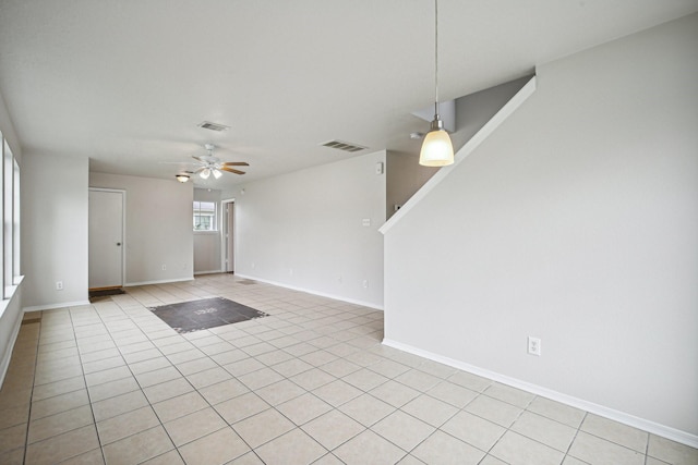 tiled empty room featuring ceiling fan