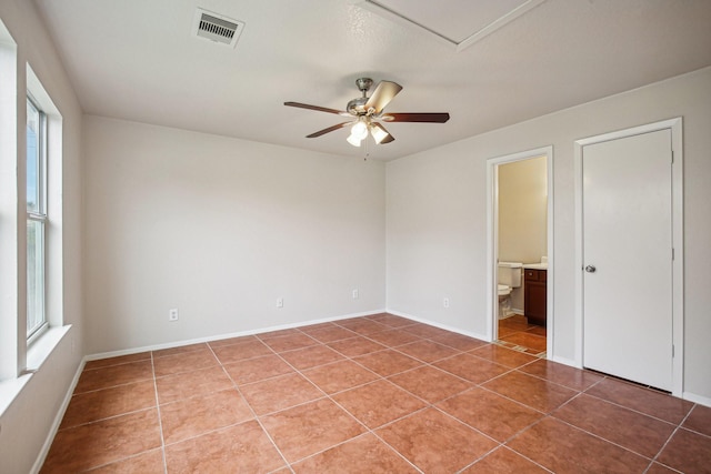 unfurnished room with tile patterned flooring, plenty of natural light, and ceiling fan