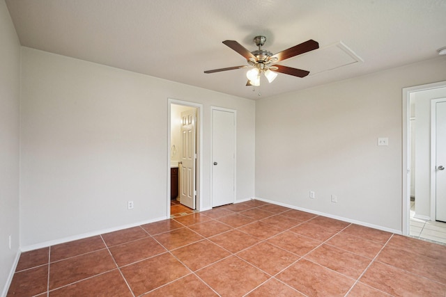 tiled spare room with ceiling fan