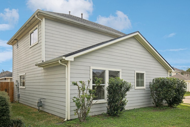 view of side of property featuring a yard