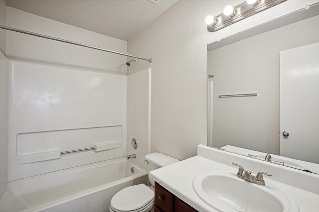 full bathroom featuring vanity, a textured ceiling, toilet, and shower / bathtub combination