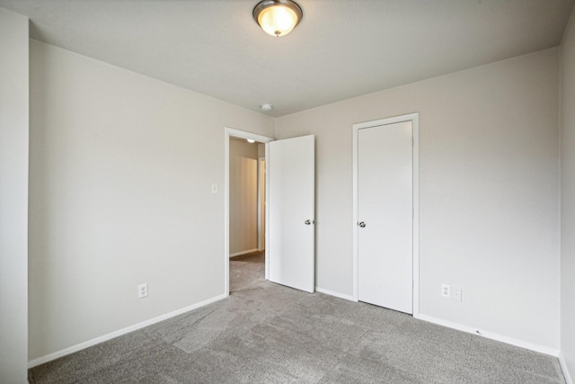 unfurnished bedroom featuring light colored carpet