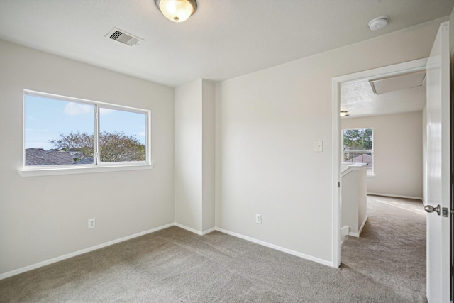 carpeted spare room with a healthy amount of sunlight