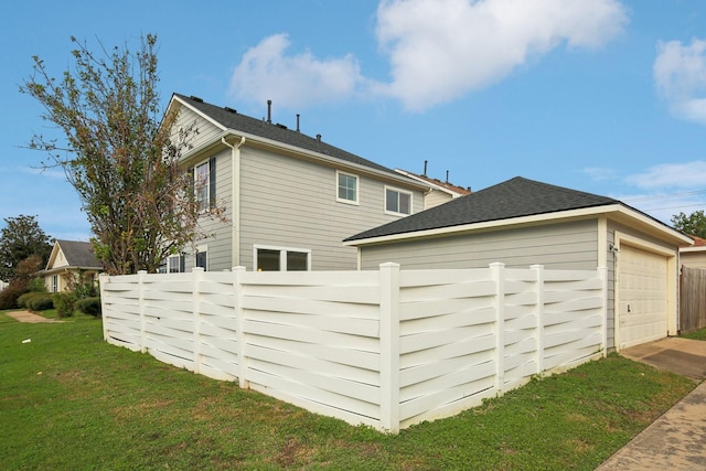 exterior space featuring a yard and a garage