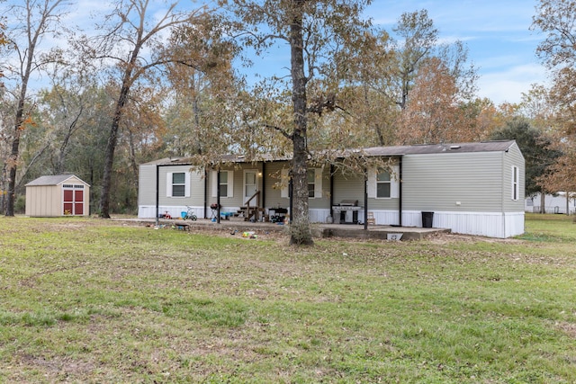 view of front of property with a storage unit and a front lawn