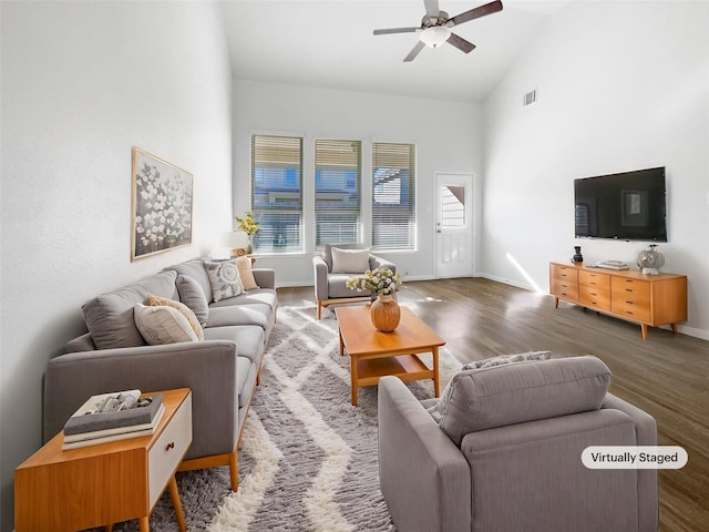 living room featuring high vaulted ceiling, ceiling fan, and dark wood-type flooring