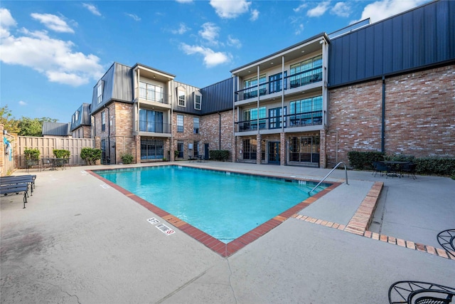 view of swimming pool featuring a patio area