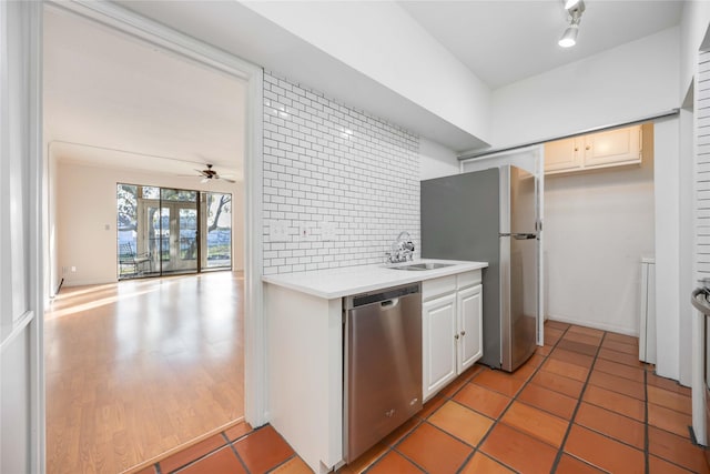 kitchen featuring ceiling fan, white cabinetry, sink, backsplash, and appliances with stainless steel finishes