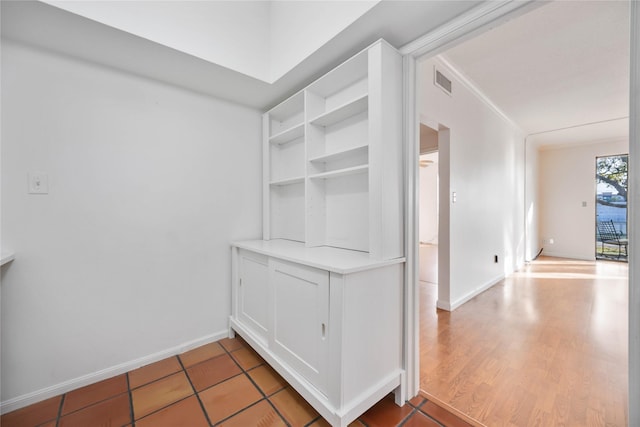 walk in closet with hardwood / wood-style floors