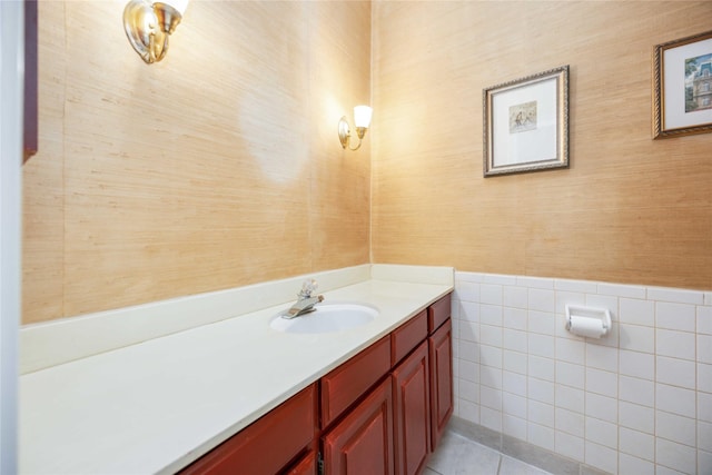 bathroom with tile patterned floors, vanity, and tile walls