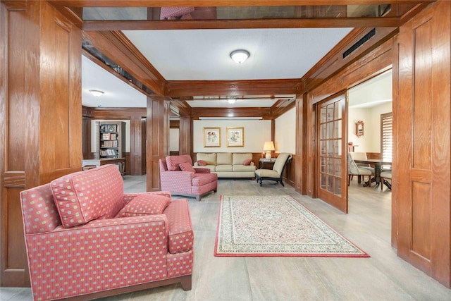 living room featuring beamed ceiling, ornamental molding, and wooden walls