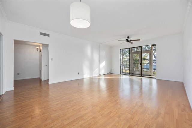 empty room with ceiling fan, light hardwood / wood-style flooring, and crown molding