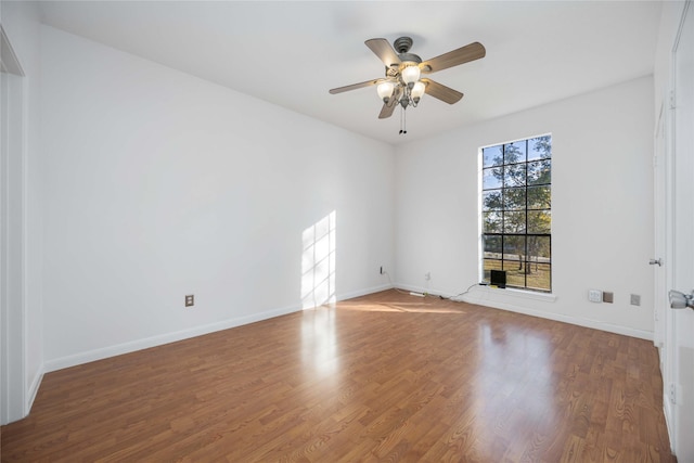 empty room featuring hardwood / wood-style flooring and ceiling fan