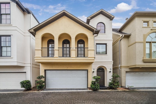 multi unit property with a balcony and a garage