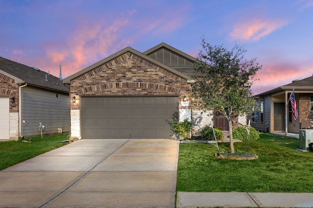 view of front facade featuring a lawn and a garage