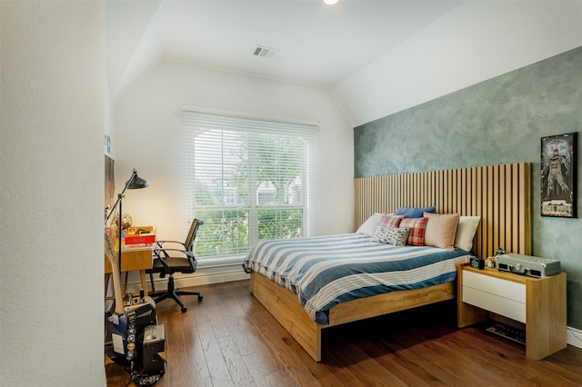 bedroom with dark wood-type flooring, visible vents, and vaulted ceiling