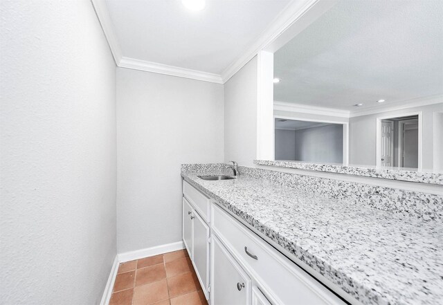 bathroom with tile patterned flooring, vanity, and ornamental molding