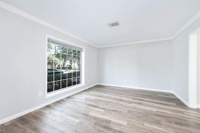 unfurnished room with hardwood / wood-style floors and ornamental molding