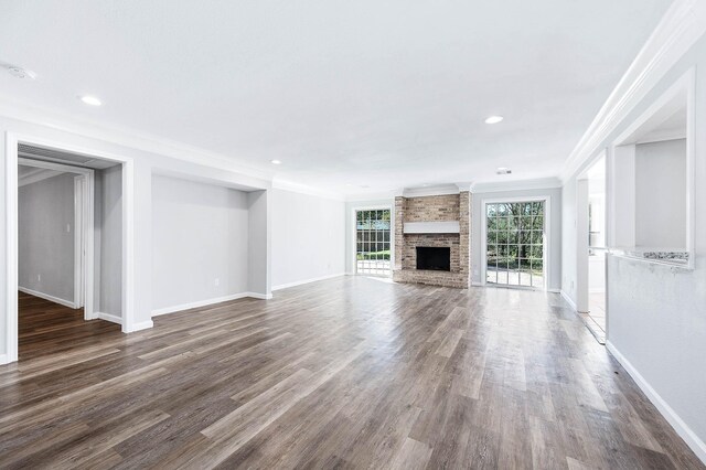 unfurnished living room featuring dark hardwood / wood-style flooring, a fireplace, and ornamental molding