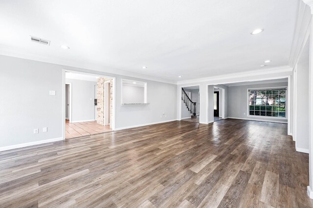 unfurnished living room with ornamental molding and light hardwood / wood-style flooring