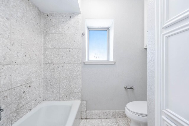 bathroom featuring a bath and toilet