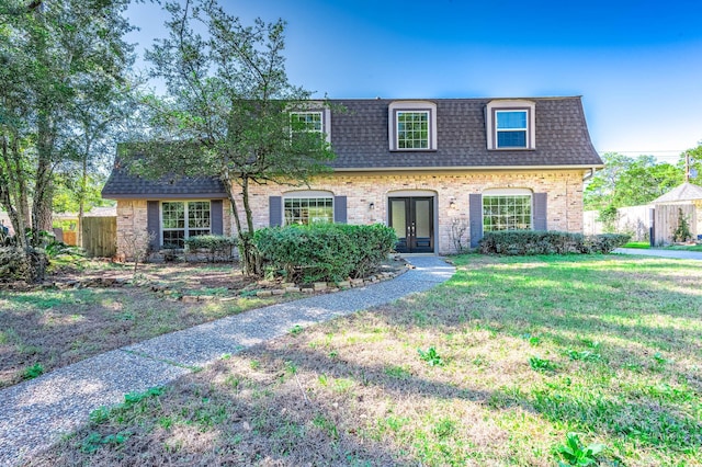 view of front of home featuring a front lawn and french doors