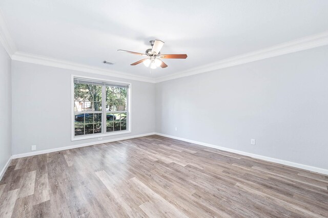 spare room with ceiling fan, light hardwood / wood-style floors, and crown molding