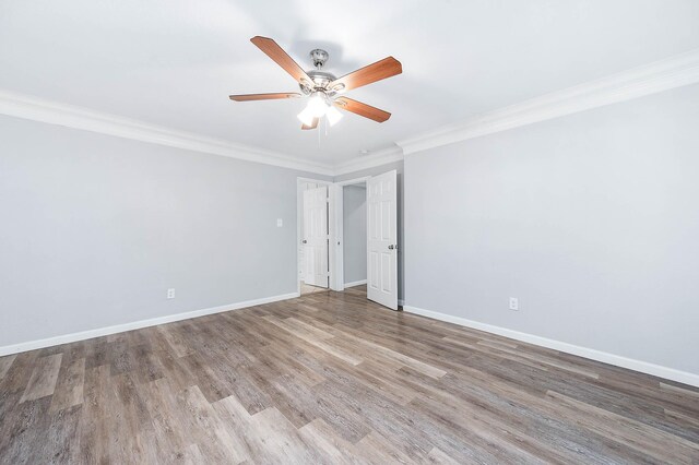 spare room featuring hardwood / wood-style floors, ceiling fan, and crown molding