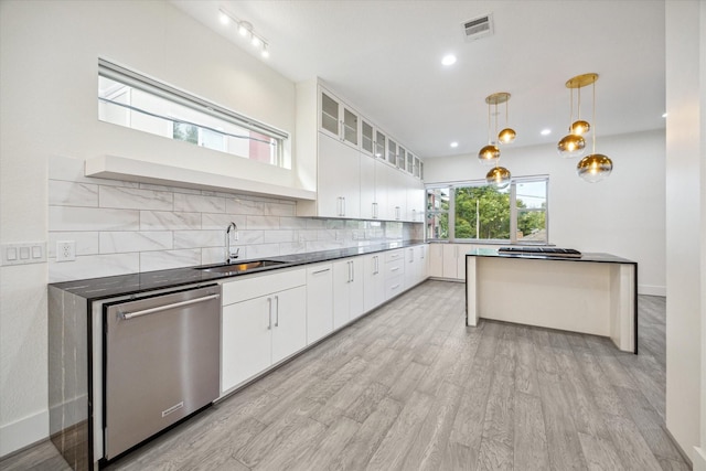 kitchen with stainless steel dishwasher, sink, pendant lighting, light hardwood / wood-style floors, and white cabinetry