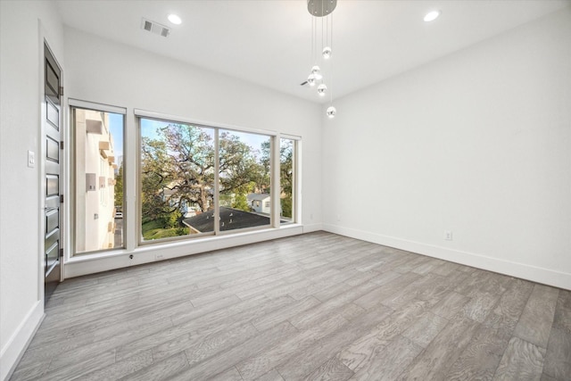 unfurnished room with light hardwood / wood-style flooring