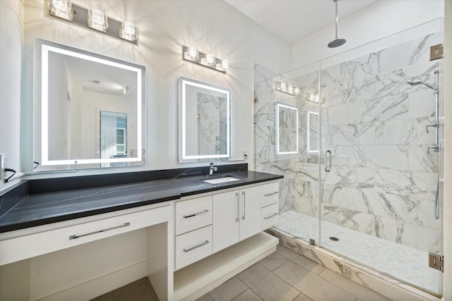 bathroom featuring tile patterned flooring, vanity, and an enclosed shower