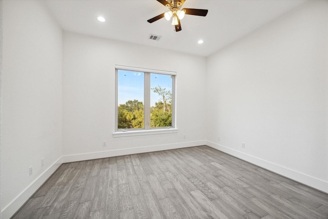 empty room featuring ceiling fan and light hardwood / wood-style flooring