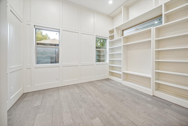 walk in closet with light wood-type flooring