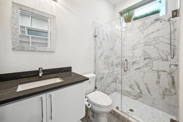 bathroom featuring vanity, toilet, and walk in shower