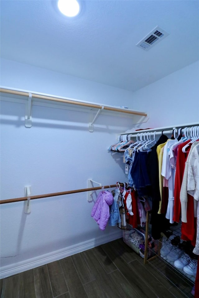 walk in closet featuring dark hardwood / wood-style flooring