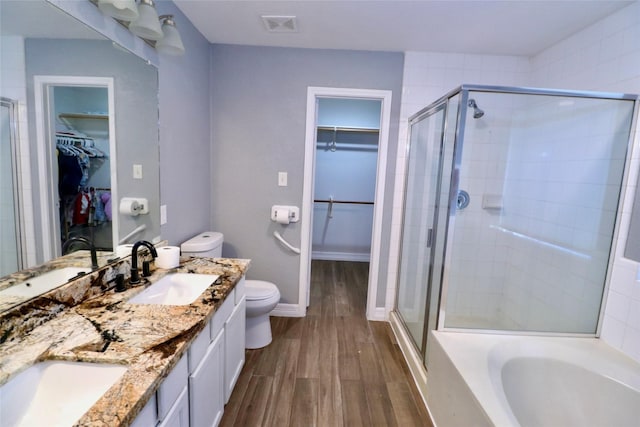 full bathroom featuring vanity, separate shower and tub, toilet, and wood-type flooring