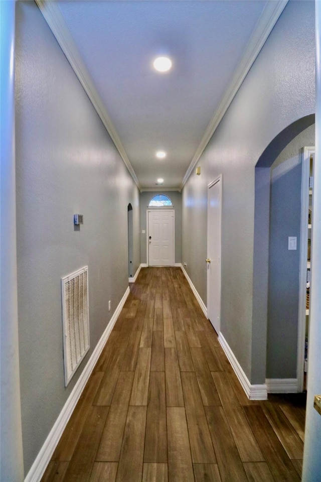 hallway featuring dark hardwood / wood-style floors and crown molding