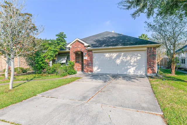 view of front of home with a garage and a front yard