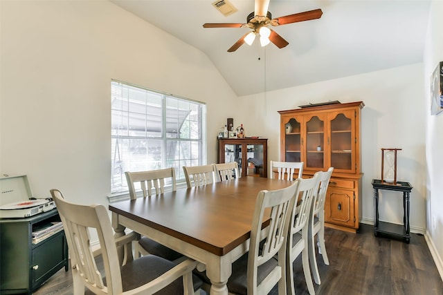 dining area with ceiling fan, dark wood-type flooring, and vaulted ceiling