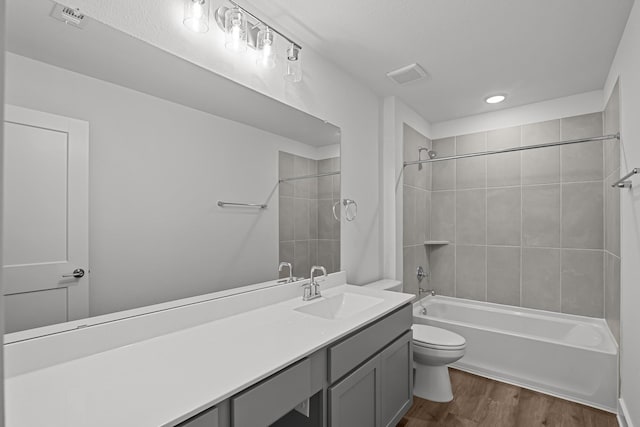21710 Persian Lake Dr, Cypress, TX 77433 - full bathroom featuring visible vents, wood finished floors, shower / washtub combination, vanity, and toilet