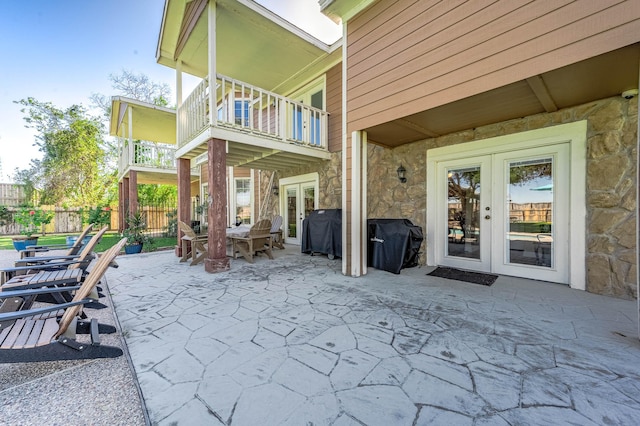 view of patio featuring french doors, a balcony, and grilling area